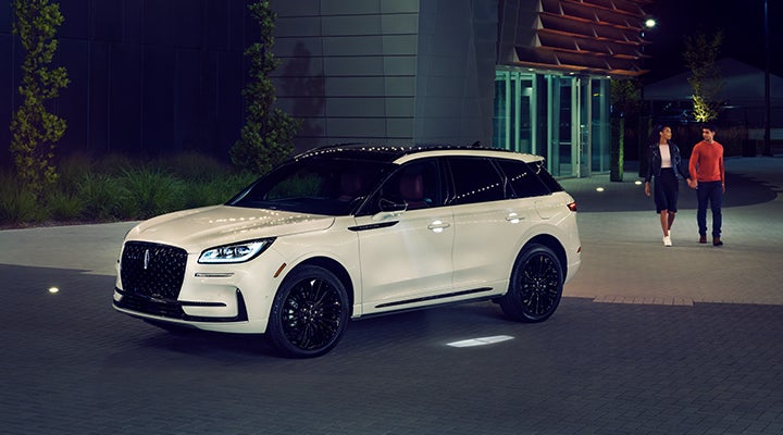 Two people approach a 2024 Lincoln Corsair® SUV featuring the available Jet Appearance Package. | Thomasville Lincoln in Thomasville GA