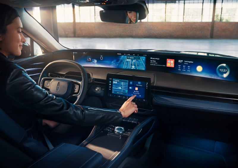 The driver of a 2024 Lincoln Nautilus® SUV interacts with the center touchscreen. | Thomasville Lincoln in Thomasville GA