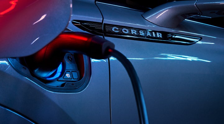 A charger plugged into the charging port of a 2024 Lincoln Corsair® Plug-in Hybrid model. | Thomasville Lincoln in Thomasville GA
