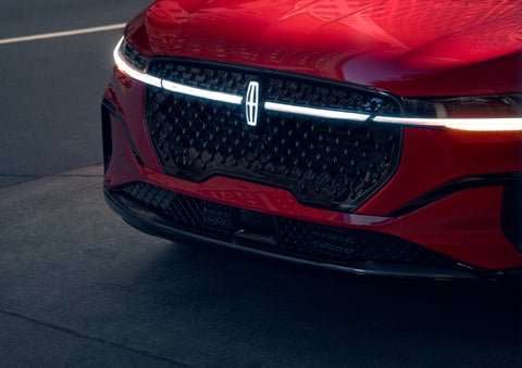 The available front LED light bar and center Lincoln Star logo glow at dusk. | Thomasville Lincoln in Thomasville GA