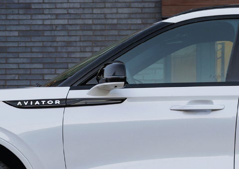 The driver’s side door and fender badging of a white 2026 Lincoln Aviator® SUV are showcased. | Thomasville Lincoln in Thomasville GA