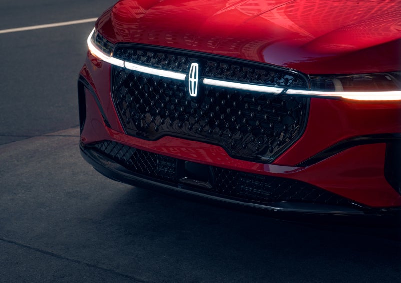 The available front LED light bar and center Lincoln Star logo glow at dusk. | Thomasville Lincoln in Thomasville GA