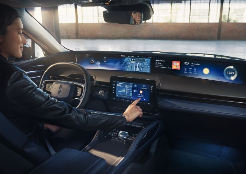 The driver of a 2026 Lincoln Nautilus® SUV interacts with the center touchscreen. | Thomasville Lincoln in Thomasville GA